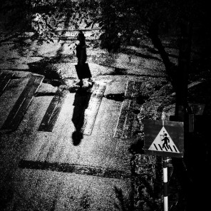 Woman walking in a dark alley.