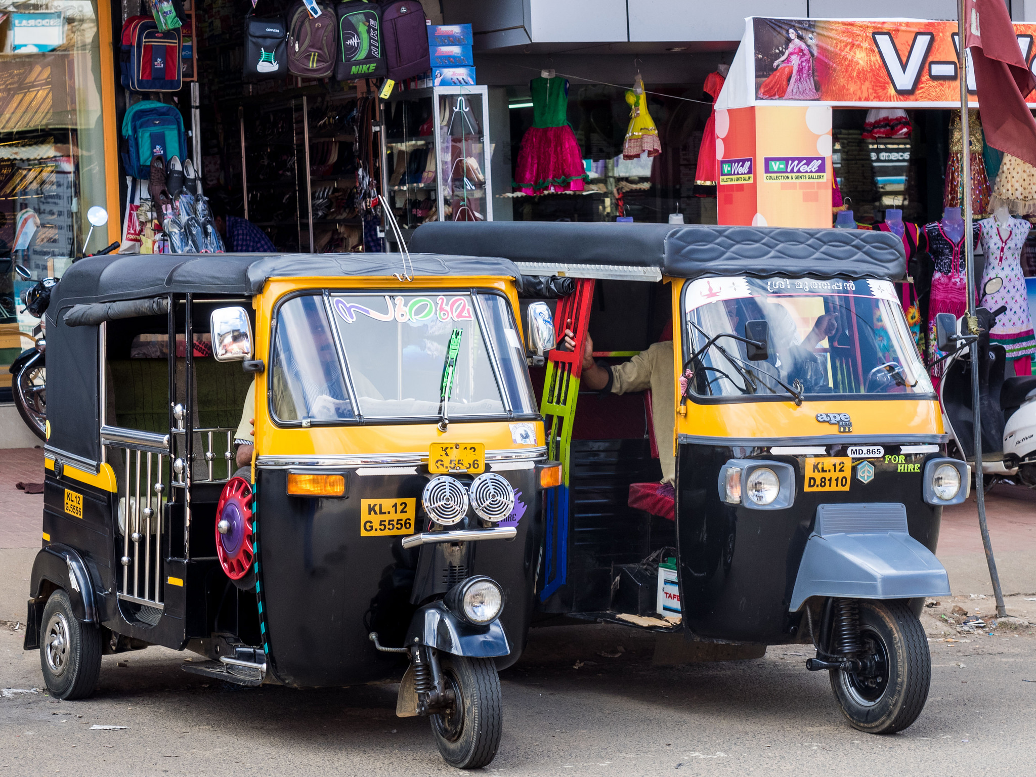 Two parked auto rickshaws.