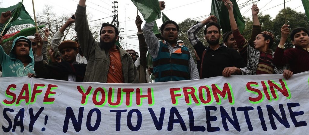 Pakistani youth shout slogans against Valentine's Day in Lahore on February 14, 2013. Pakistan's media regulator Wednesday asked television and radio stations to avoid offending religious sentiments and corrupting the nation's youth in their Valentine's Day broadcasts. AFP PHOTO/Arif ALI (Photo credit should read Arif Ali/AFP/Getty Images)